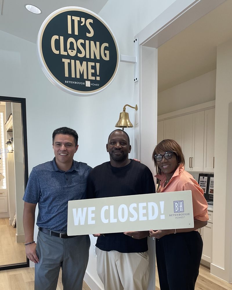 Perea Mortgage clients celebrating their home closing with a We Closed sign